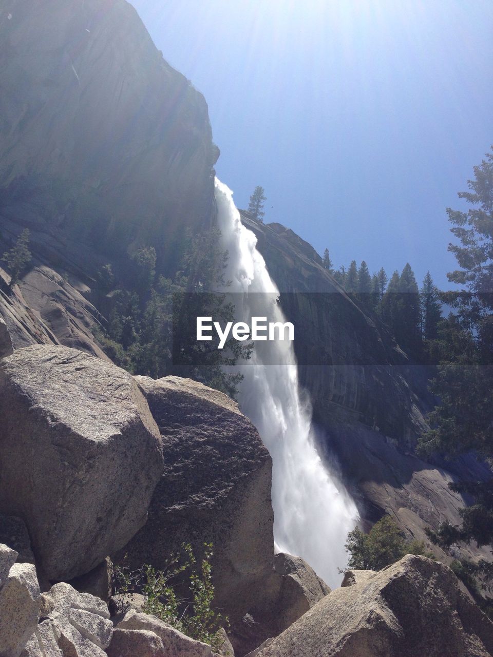 Low angle view of waterfall against sky