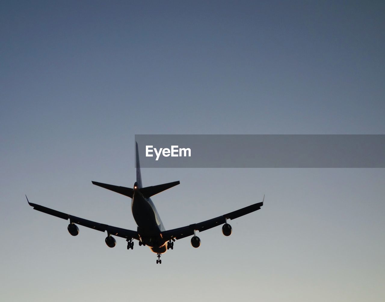 Low angle view of helicopter flying against blue sky