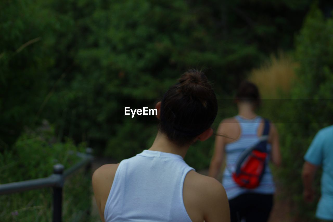 Rear view of woman walking in forest