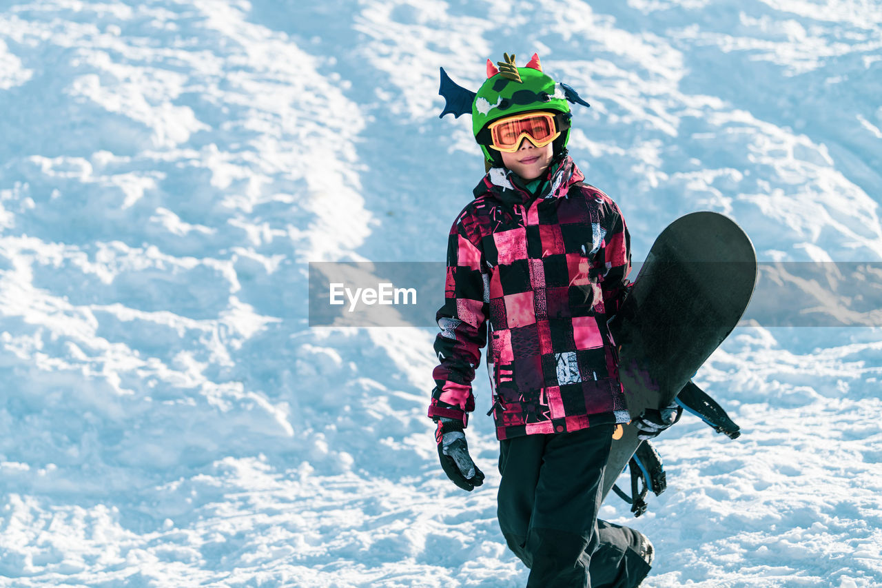 Portrait of boy with snowboard