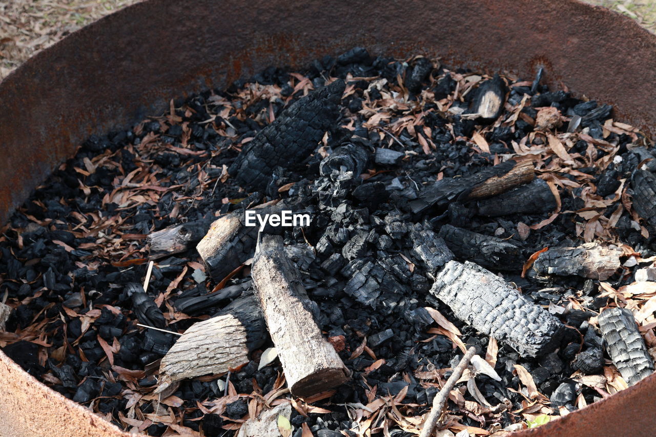 HIGH ANGLE VIEW OF BONFIRE ON WOODEN SURFACE