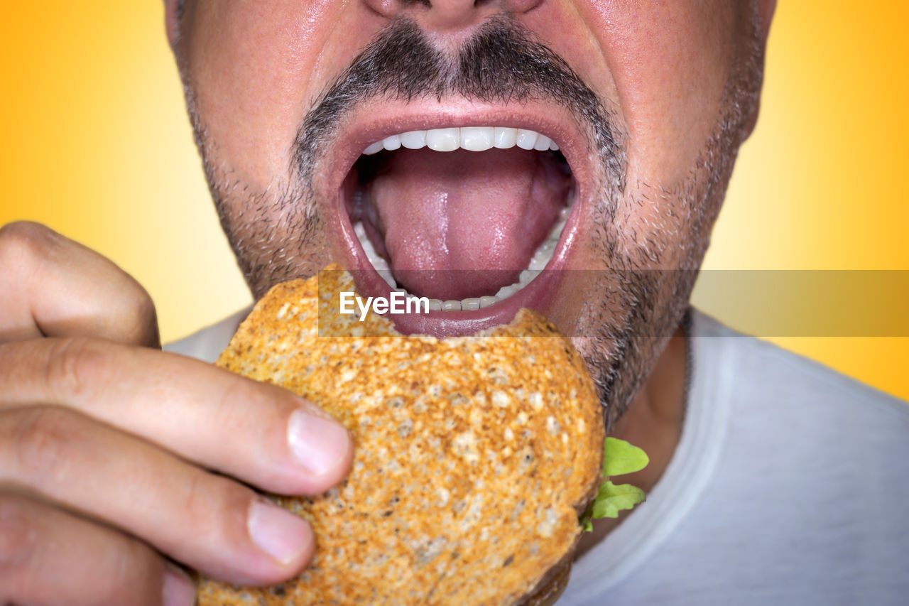 cropped hand of woman holding food in plate