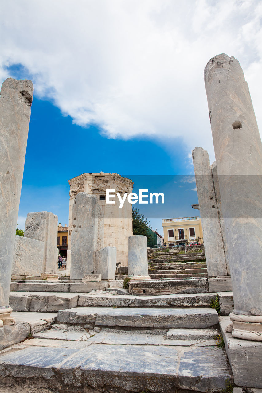 Tourists visiting the ancient ruins at the roman agora in athens