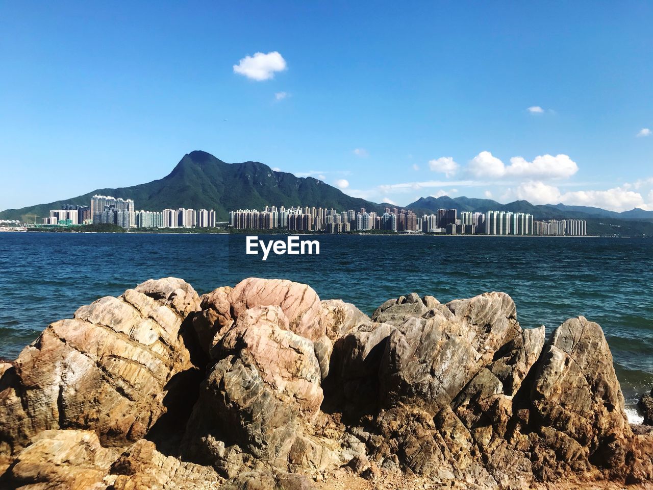 Scenic view of bay against blue sky