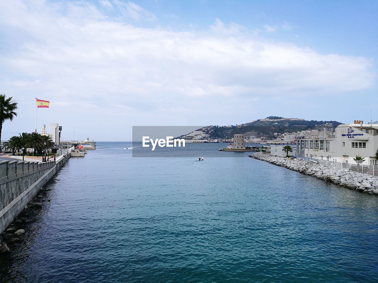 SCENIC VIEW OF SEA BY BUILDINGS AGAINST SKY