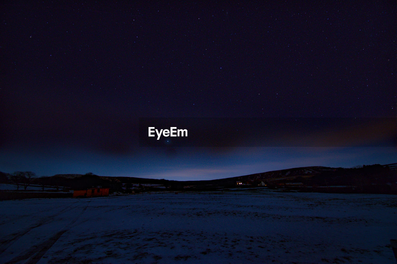 Scenic view of mountains against sky at night