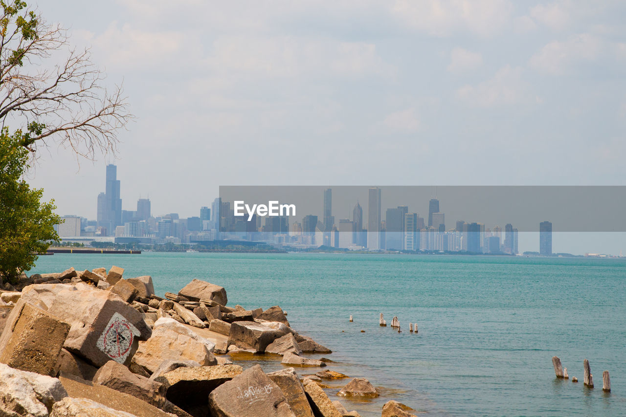 scenic view of sea in city against sky