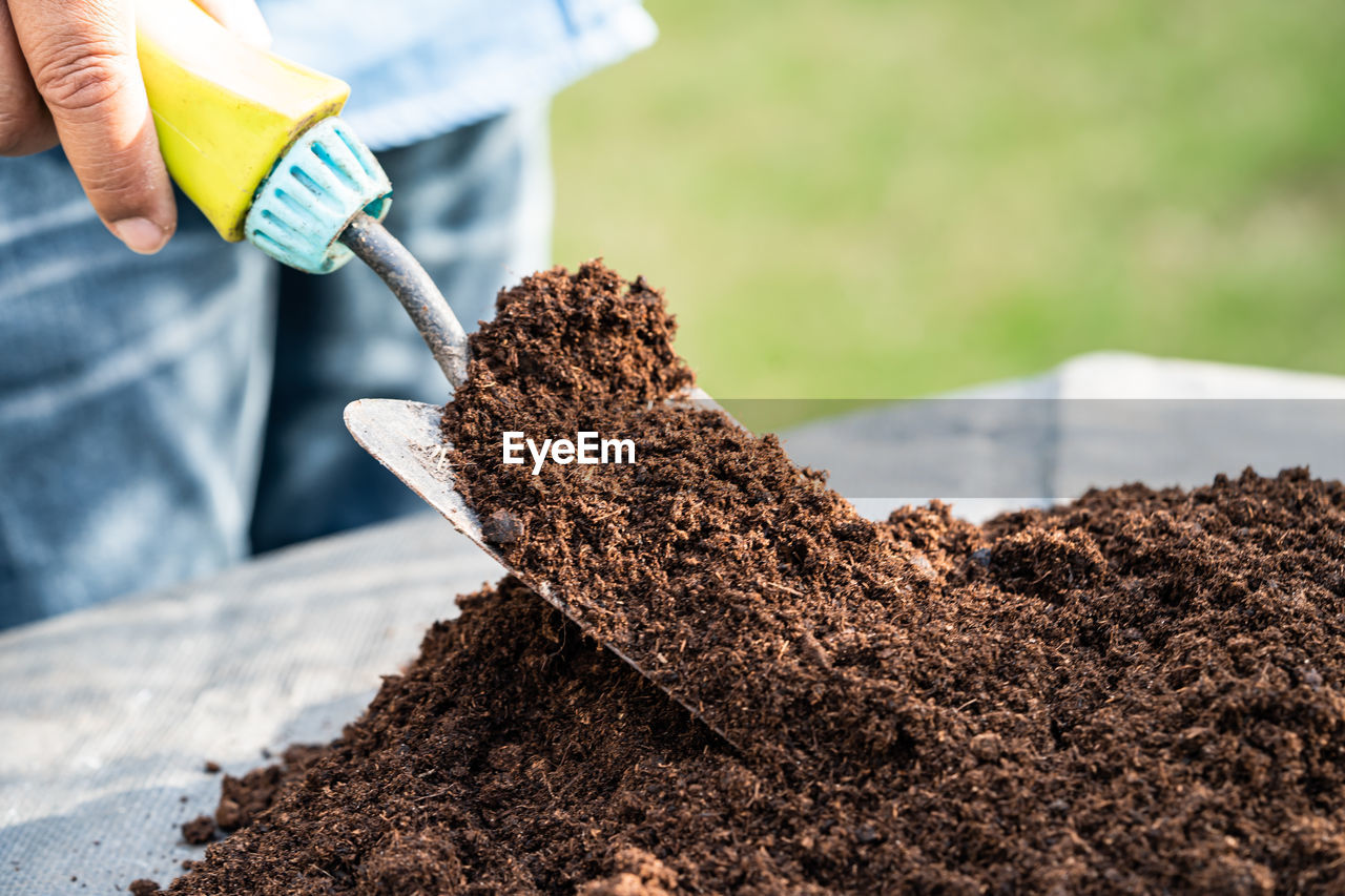 cropped hand of person watering plants