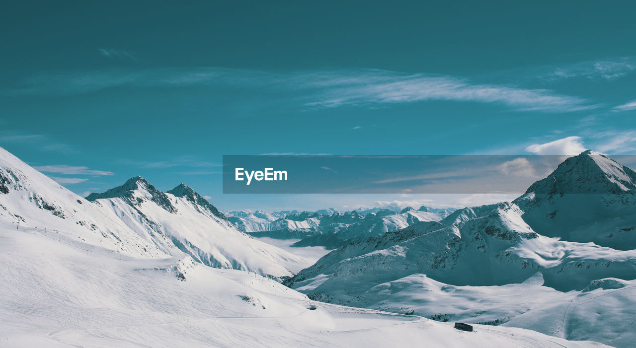 Scenic view of snowcapped mountains against sky