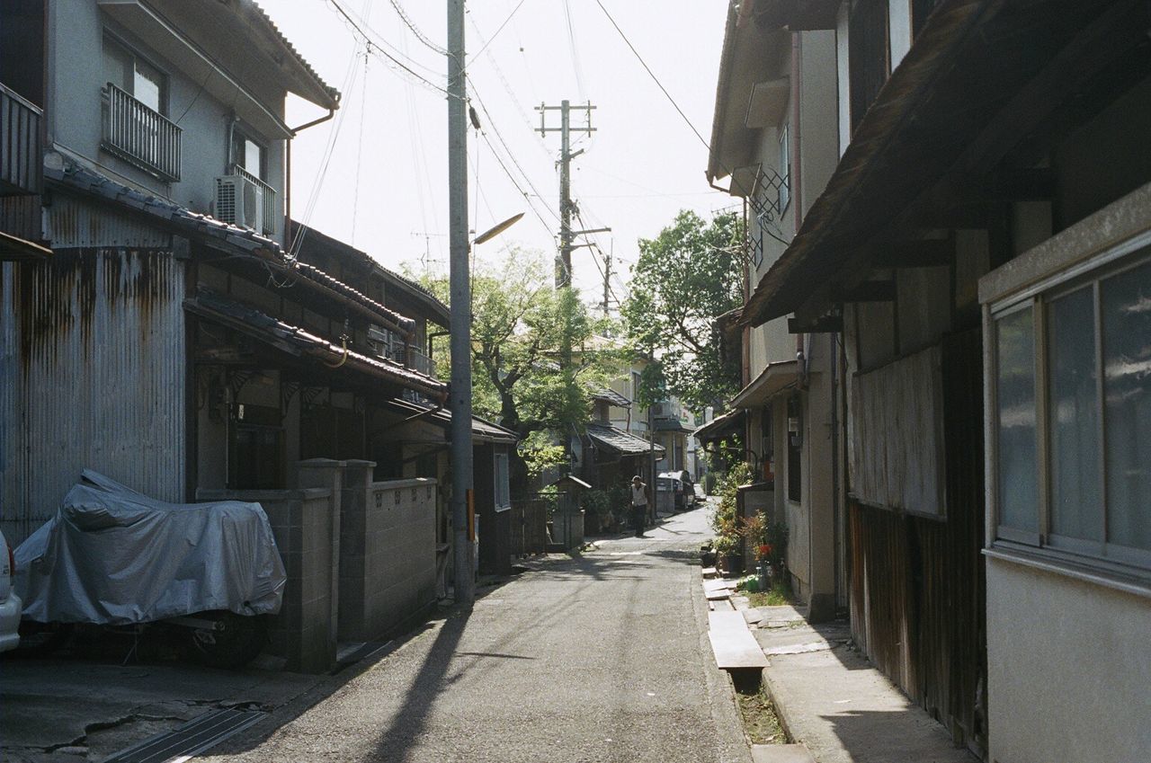 NARROW ALLEY WITH BUILDINGS IN BACKGROUND