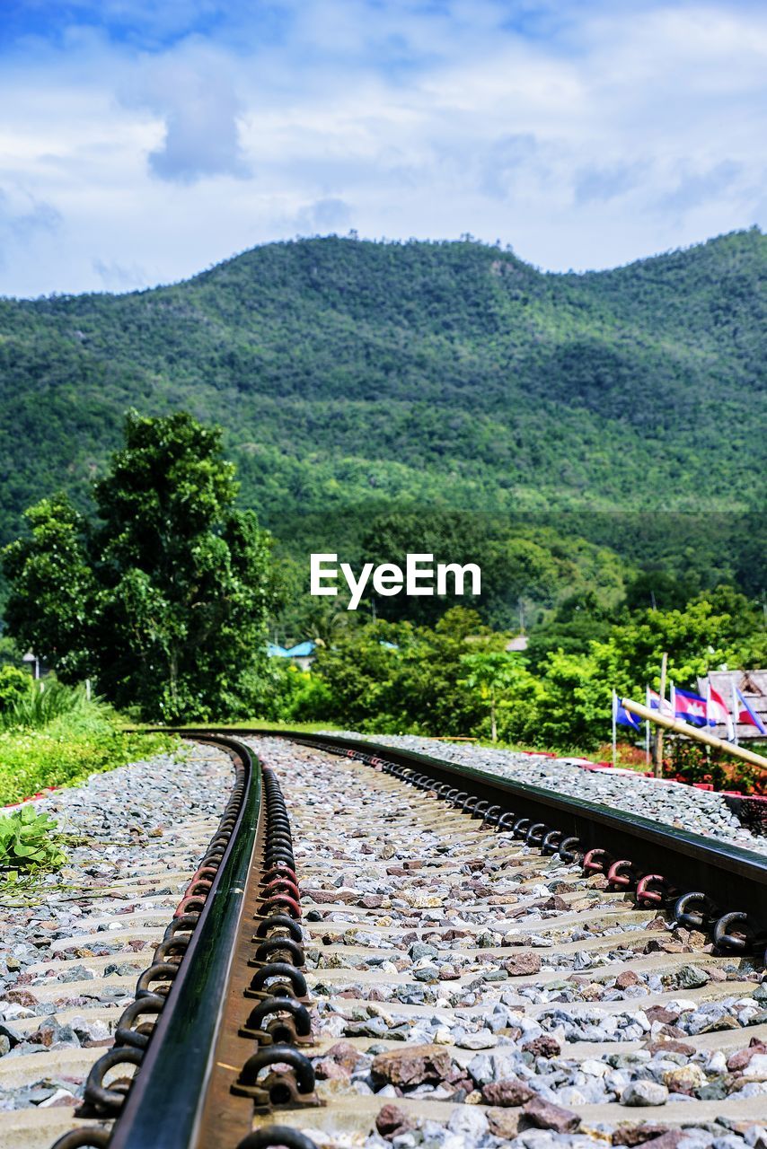 HIGH ANGLE VIEW OF RAILROAD TRACKS AMIDST TREES AGAINST SKY