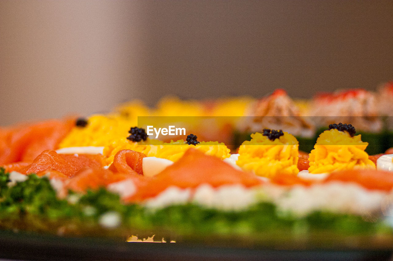 CLOSE-UP OF ORANGE SLICE ON TABLE