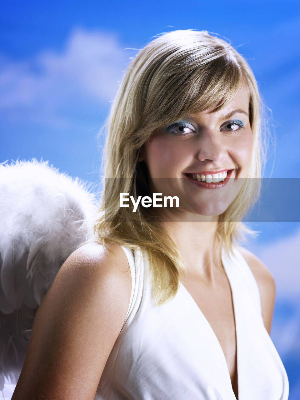 Portrait of beautiful young woman wearing angel wings