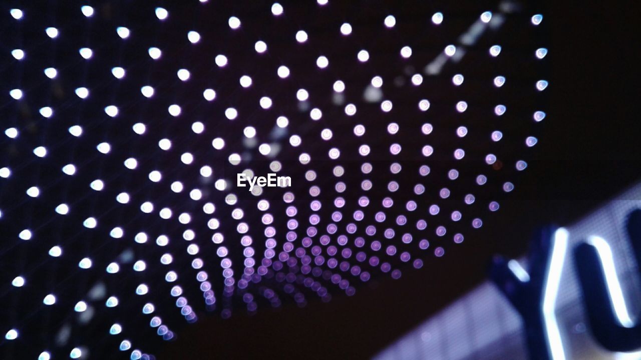 LOW ANGLE VIEW OF ILLUMINATED LIGHTING EQUIPMENT