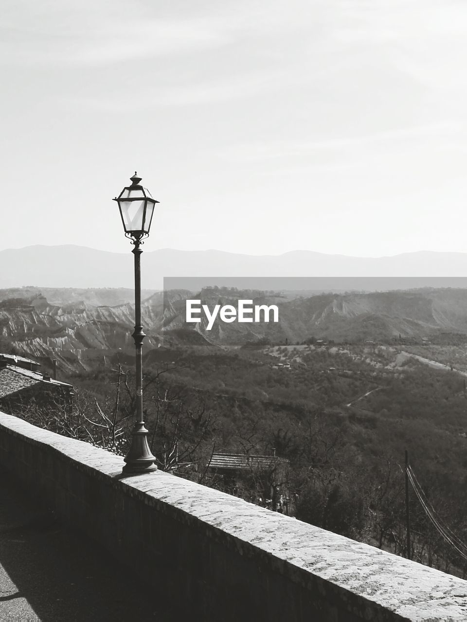 Street light and mountains against clear sky