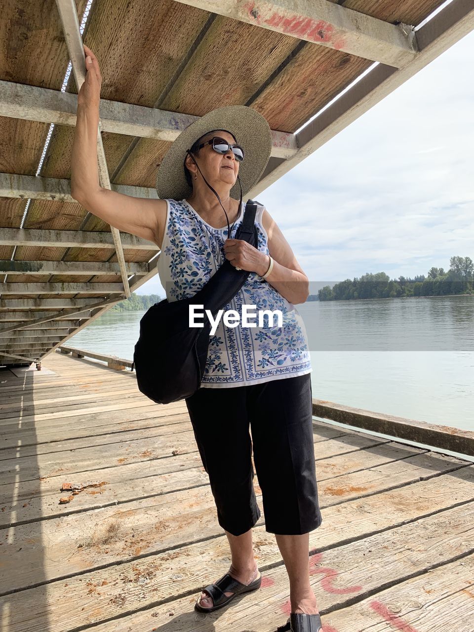 Full length of woman standing on pier over lake