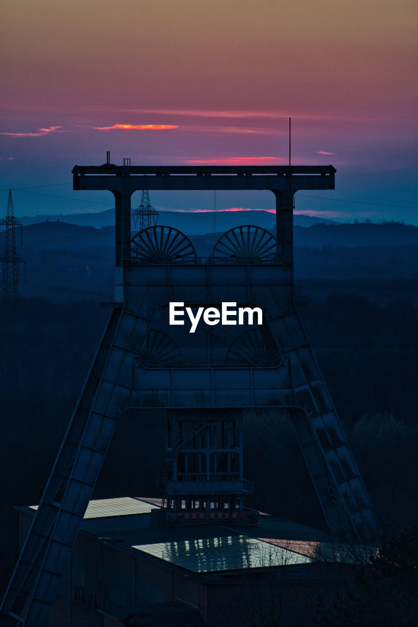 Vertical shot of a headframe tower after sunset at halde hoheward in herten, germany