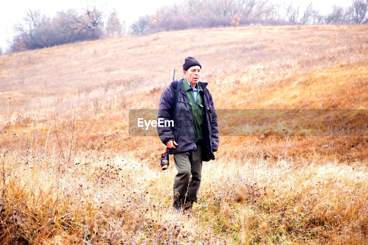 Full length of a man walking in field