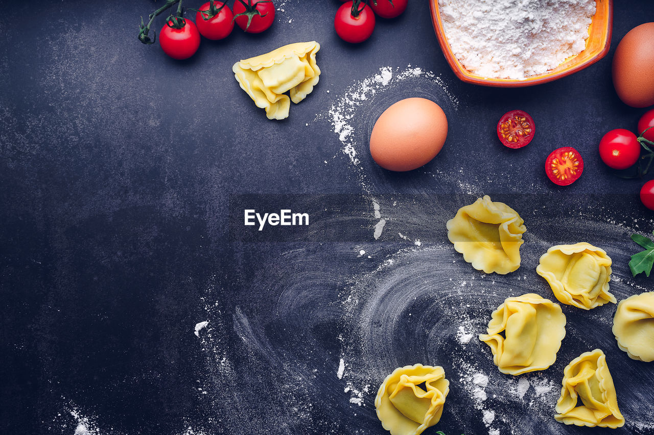 Italian pasta with ingredients and black background. gastronomic concept