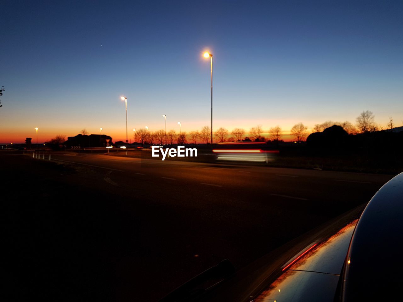 CARS ON ROAD AT DUSK