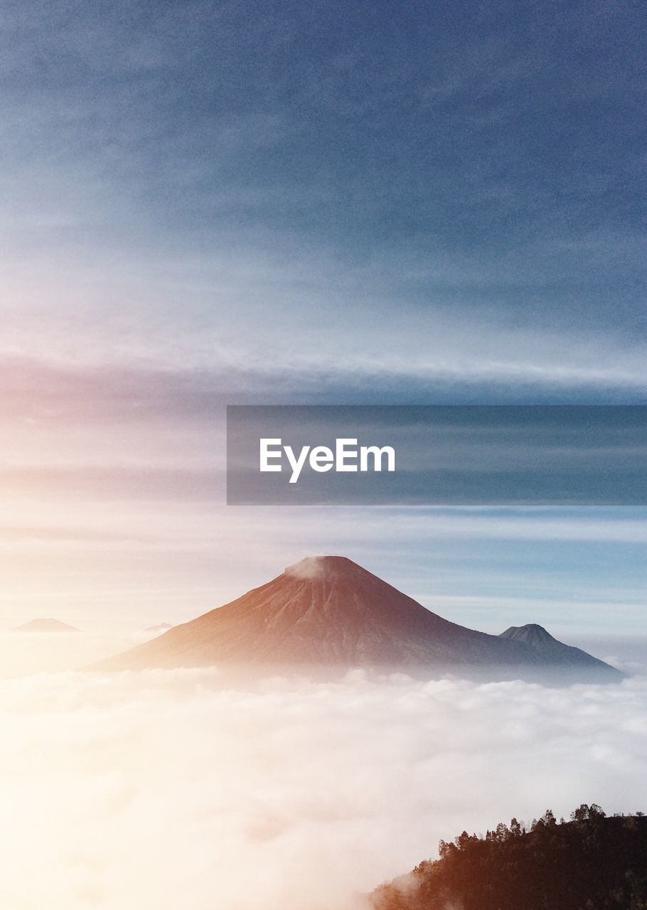 View of volcanic landscape against cloudy sky