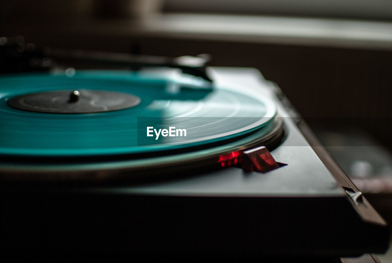 Close-up of turquoise record playing in turntable