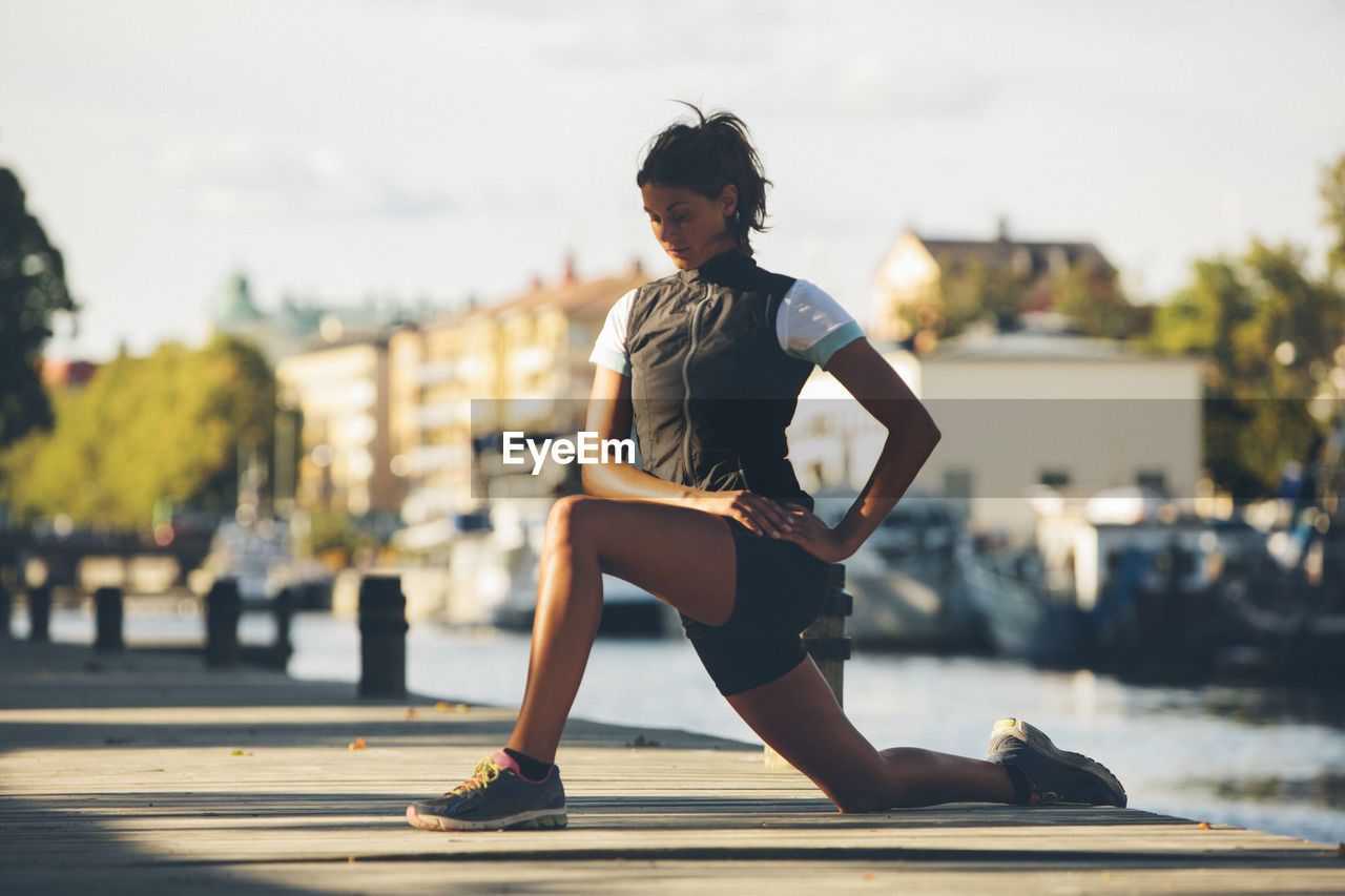 Young woman stretching, uppsala, sweden