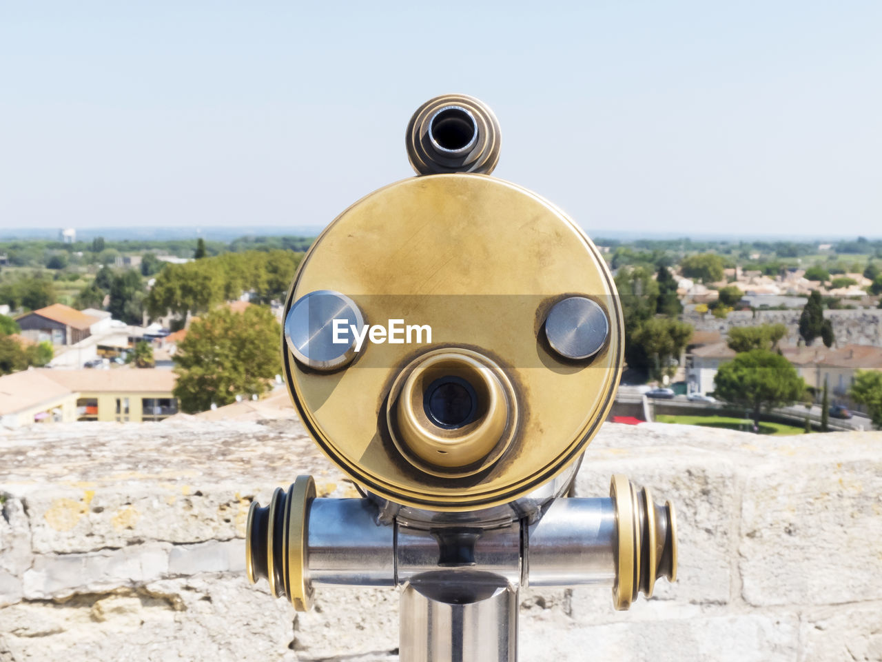 Close-up of coin-operated binoculars against sky in city