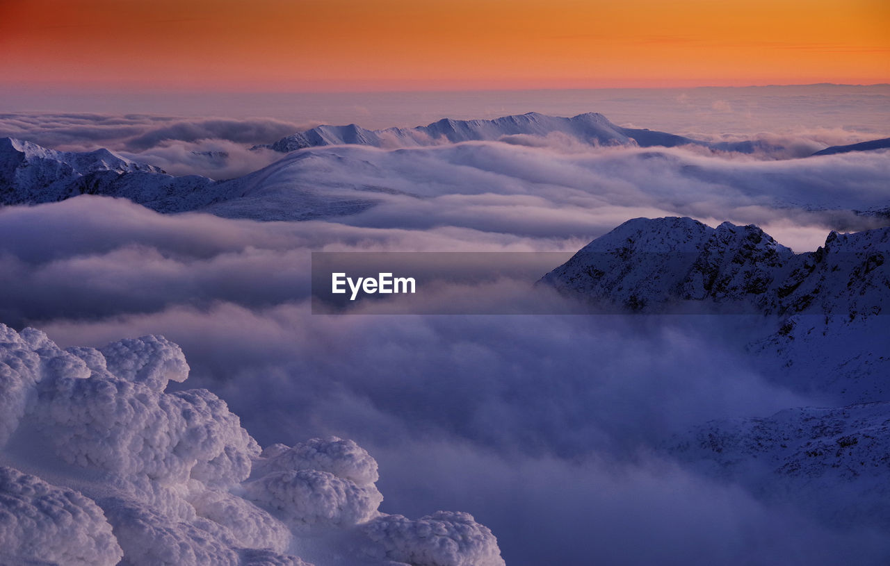 MAJESTIC SNOWCAPPED MOUNTAINS AGAINST SKY DURING SUNSET