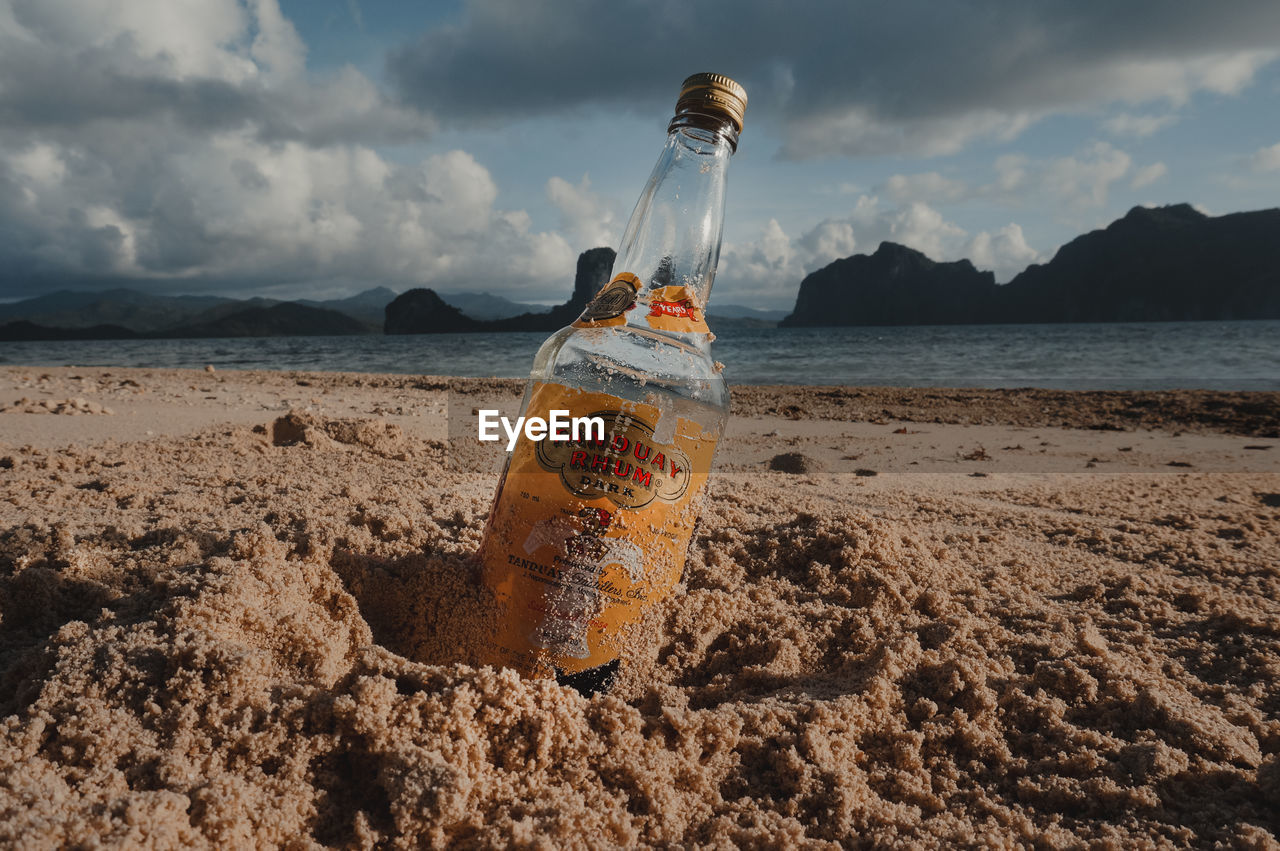 PANORAMIC VIEW OF WATER BOTTLE ON BEACH