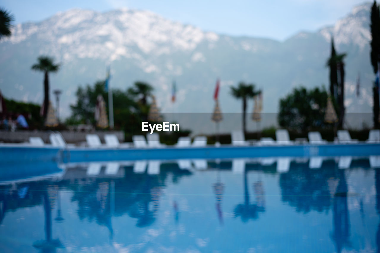 Reflection of trees in swimming pool