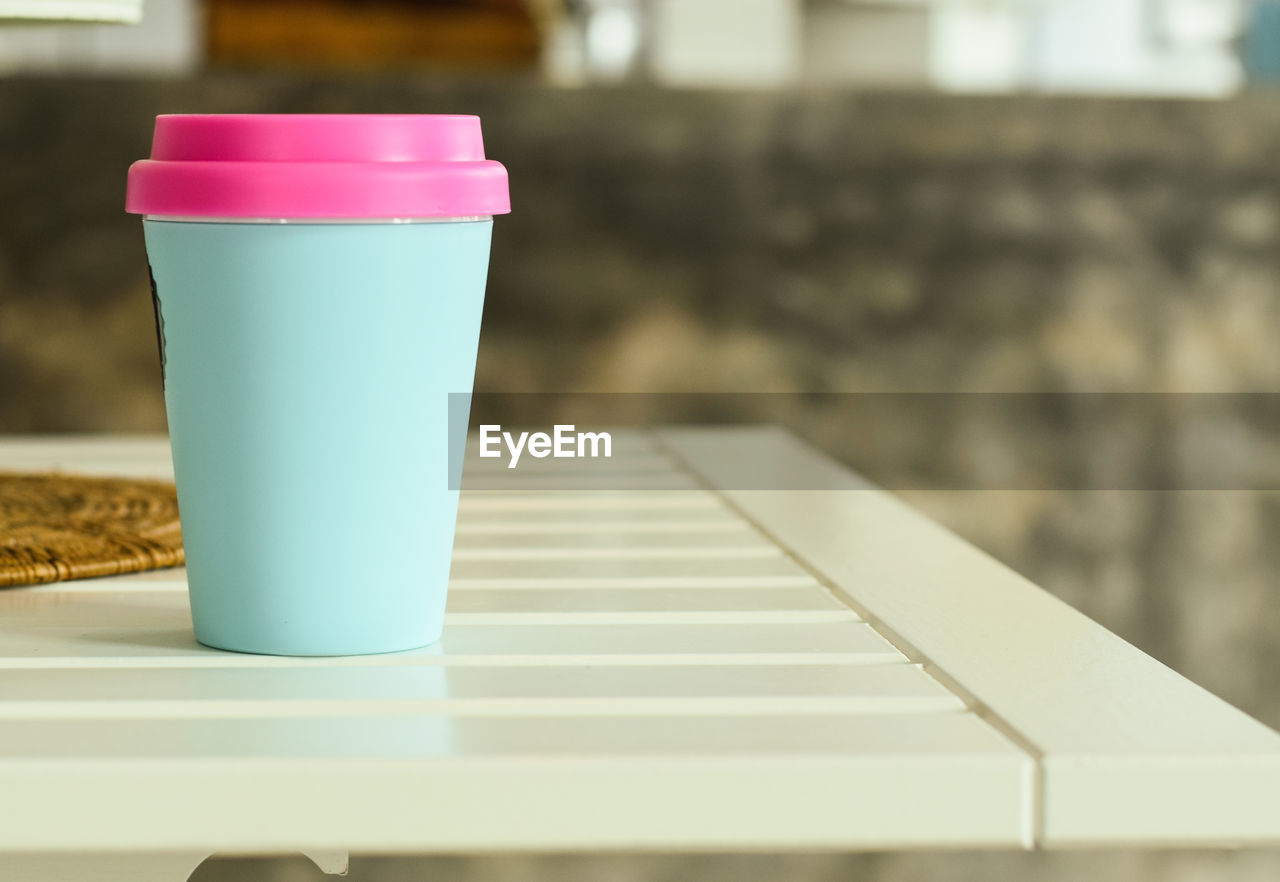 Close-up of disposable cup on table