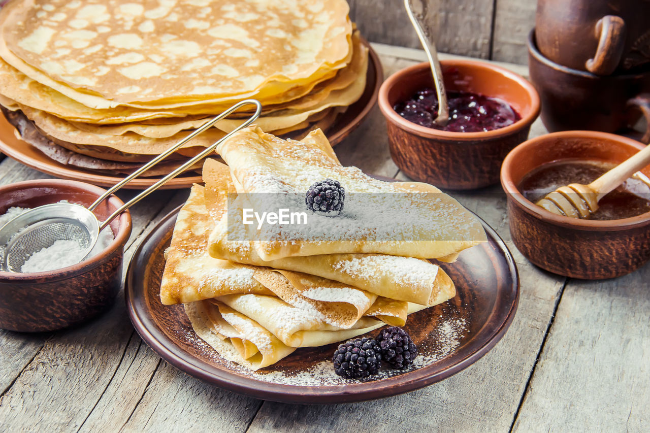 food, food and drink, dish, meal, breakfast, fast food, freshness, pancake, healthy eating, cuisine, wood, no people, bowl, bread, wellbeing, high angle view, basket, indoors, table, container, still life, sweet food, fruit, plate, snack