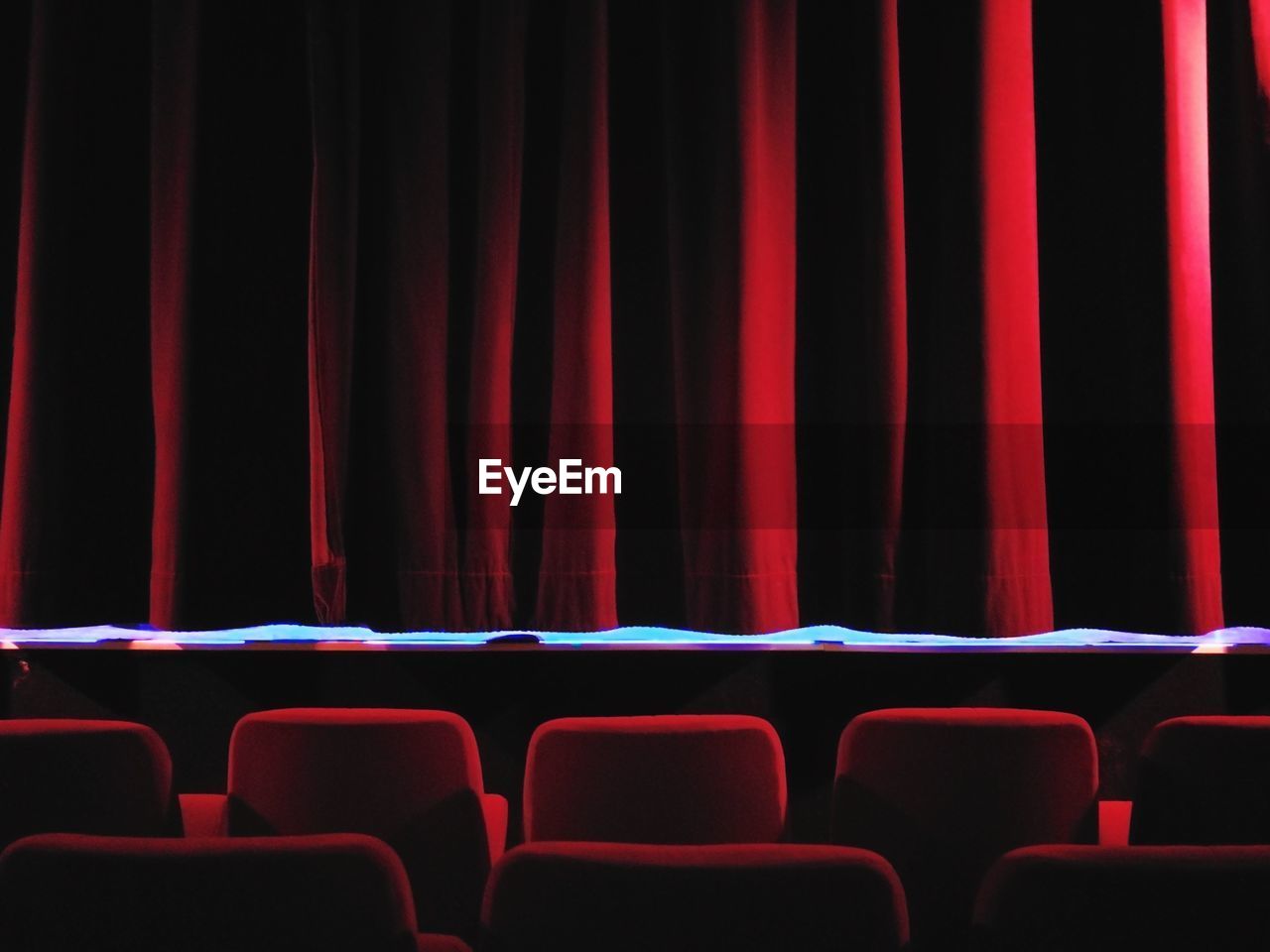 Empty red chairs in stage theater