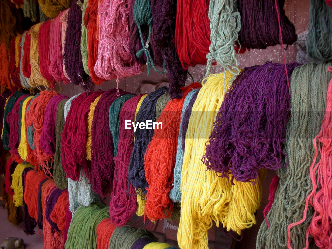 Full frame shot of multi colored umbrellas hanging at market stall