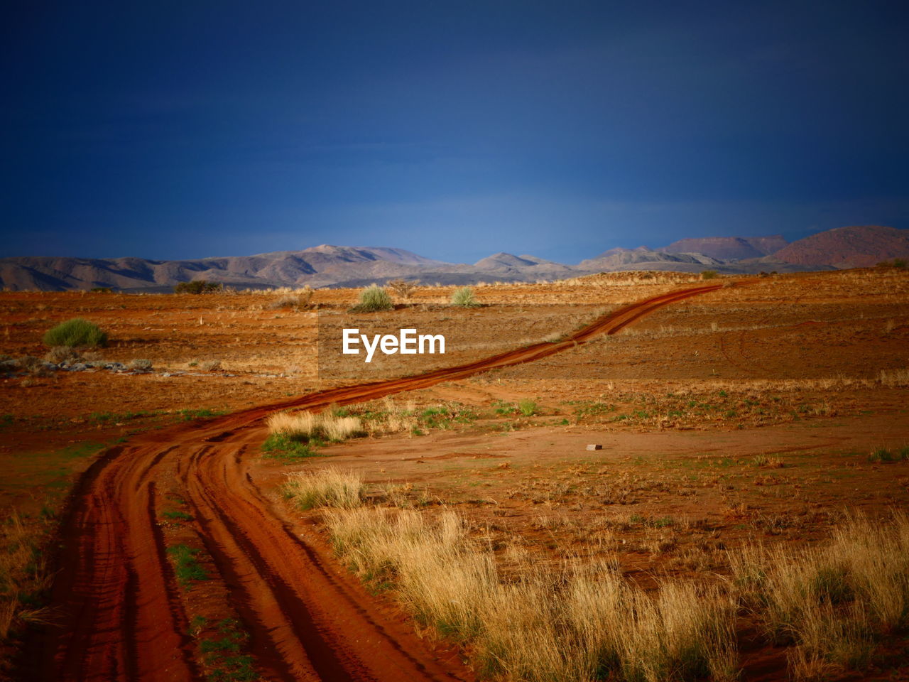 Dirt road along countryside landscape