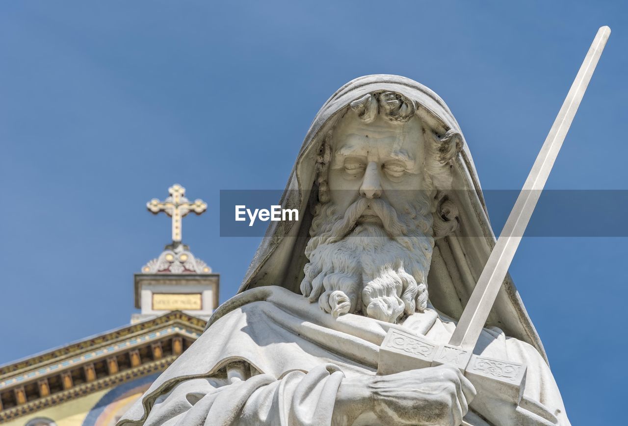 Male statue against basilica of saint paul outside the walls