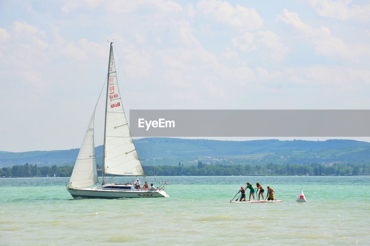 PEOPLE ENJOYING IN BOAT SAILING ON SEA