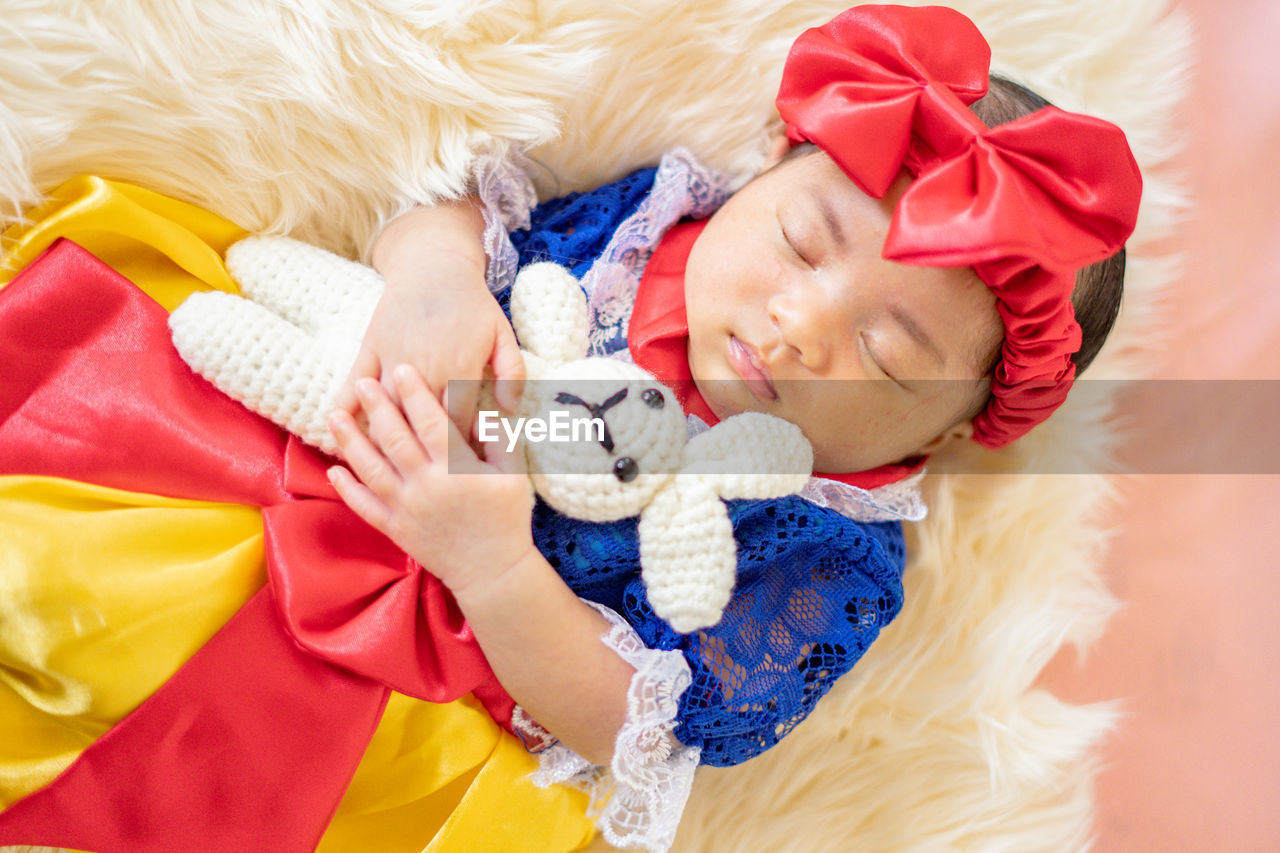 High angle view of cute girl with teddy bear