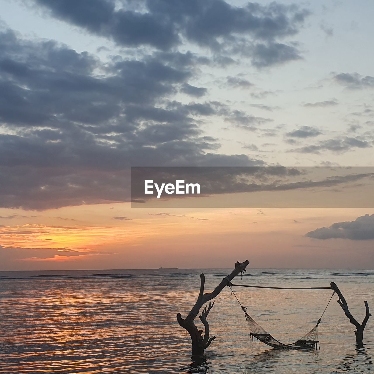 SCENIC VIEW OF BEACH DURING SUNSET