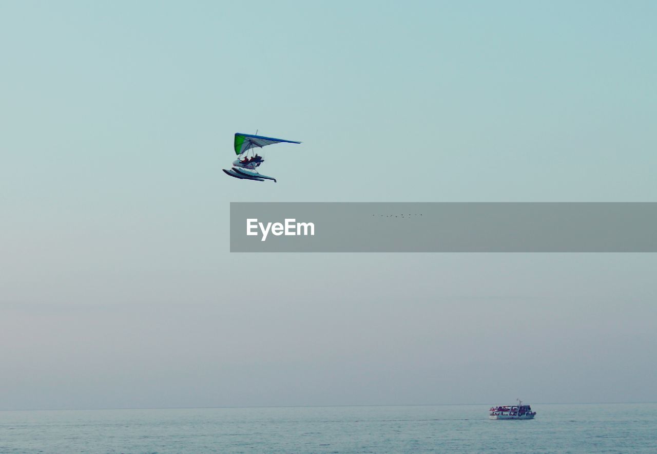 VIEW OF HELICOPTER IN SEA AGAINST CLEAR SKY