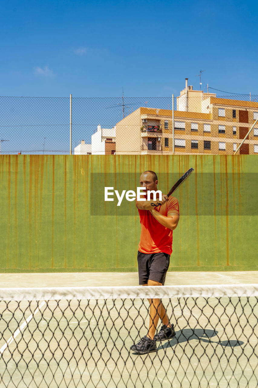 Full length of man playing tennis