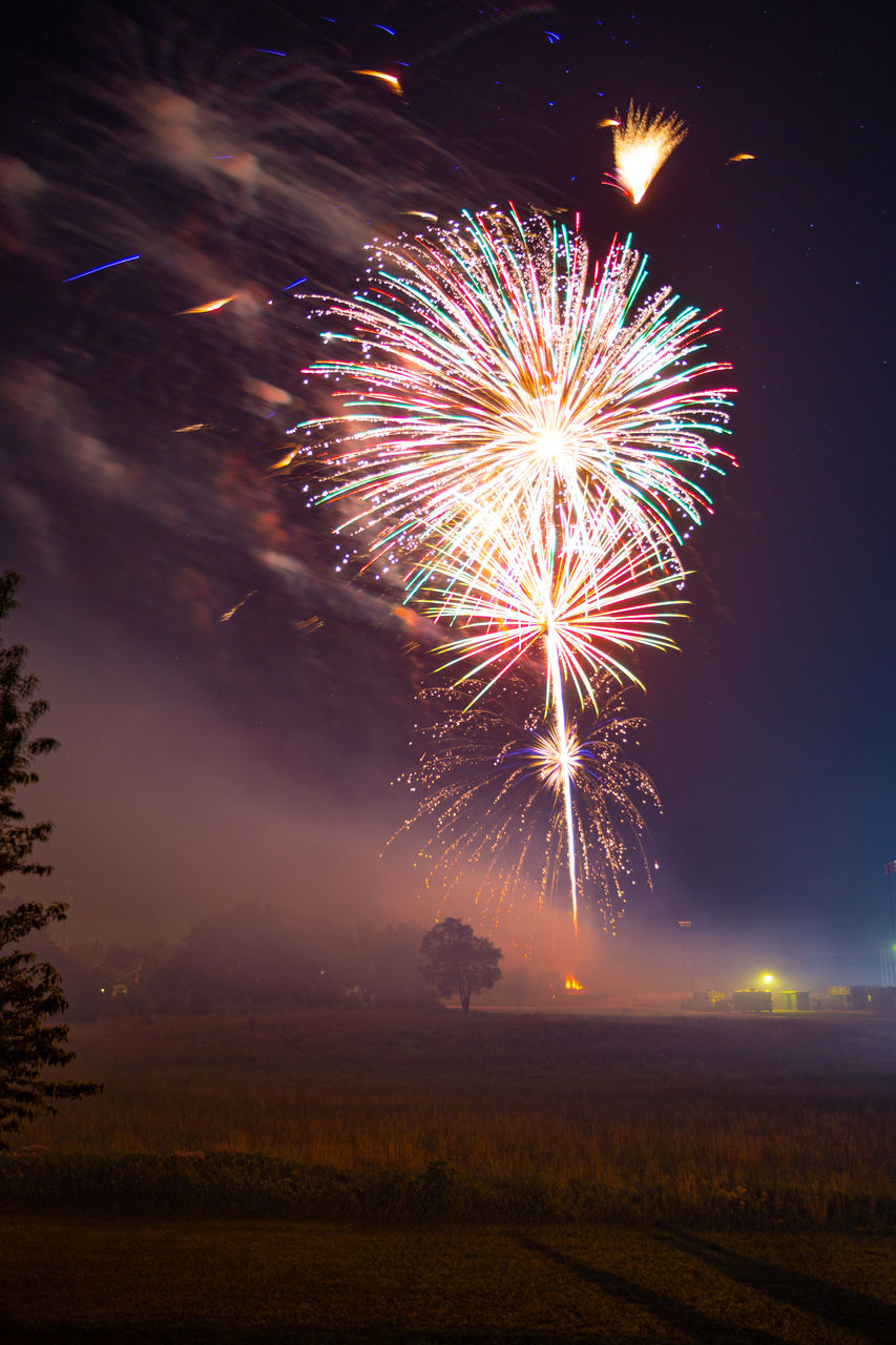 low angle view of firework display at sunset