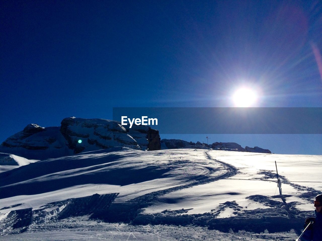 Sun shining over snow covered field