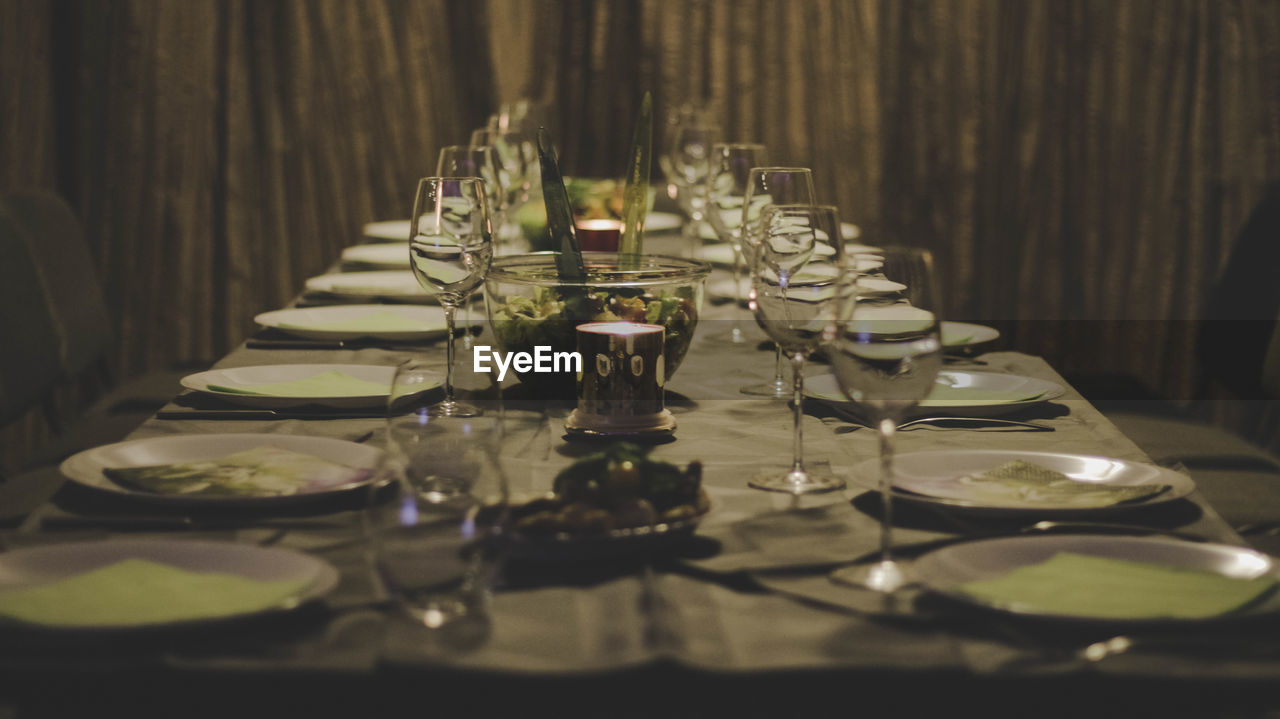 CLOSE-UP OF GLASSES ON TABLE IN KITCHEN