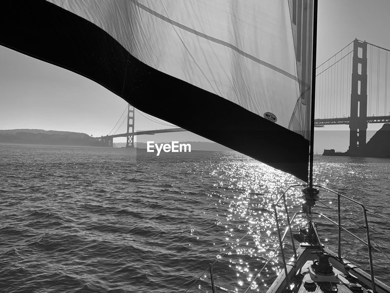 water, black and white, transportation, sea, monochrome, sailing, monochrome photography, architecture, boat, nautical vessel, nature, ship, built structure, bridge, mode of transportation, sky, travel, sailboat, vehicle, no people, travel destinations, outdoors, rippled, day, city, environment, watercraft, beauty in nature