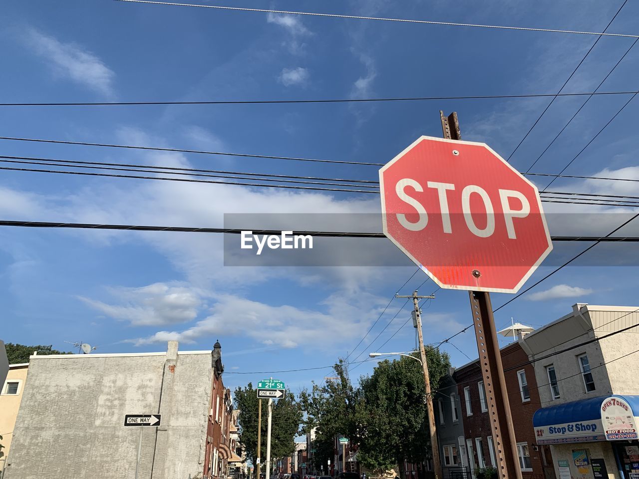 LOW ANGLE VIEW OF ROAD SIGN AGAINST BUILDINGS