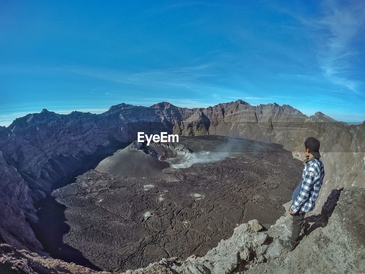 Man looking at view on volcanic landscape