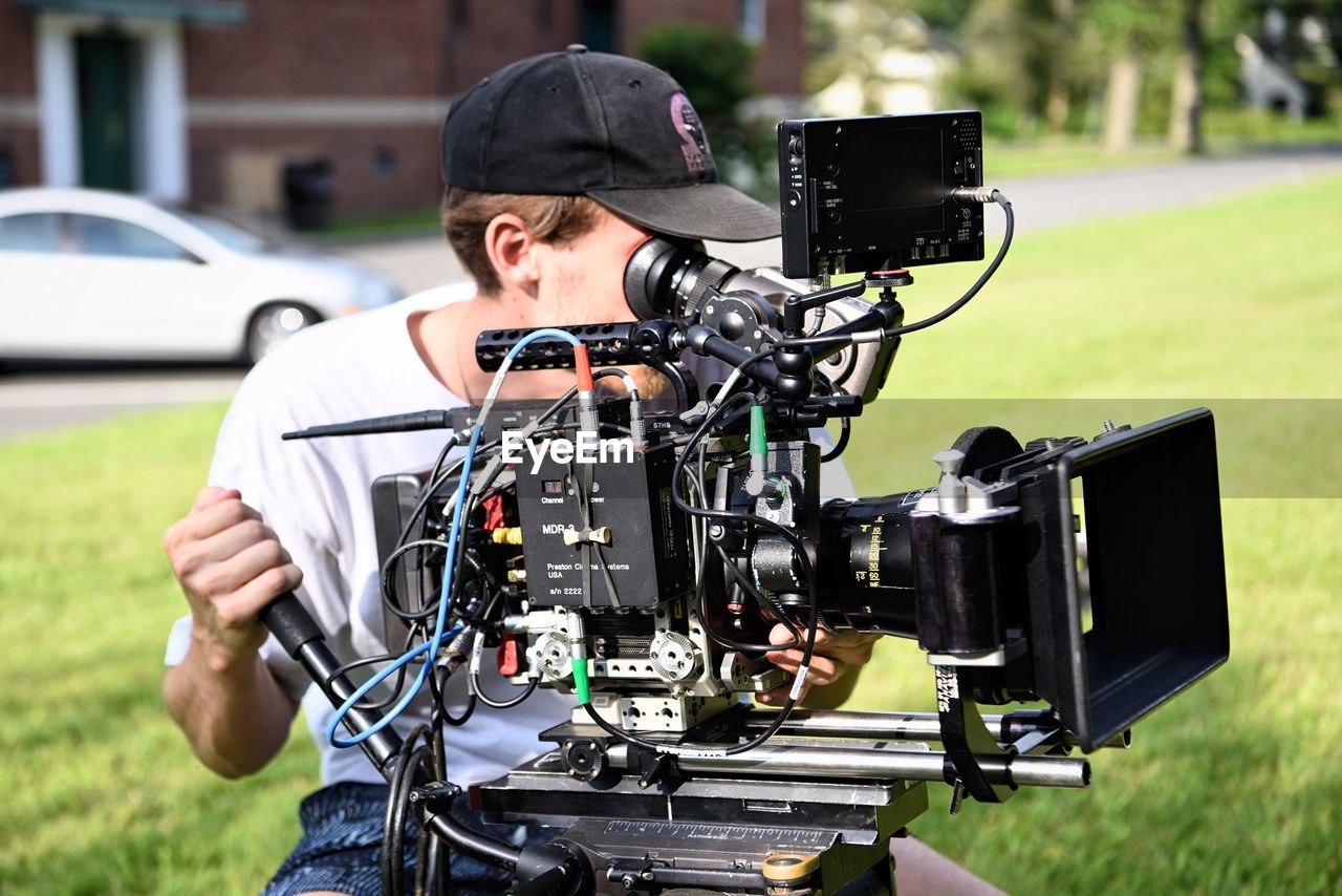 MAN PHOTOGRAPHING IN FIELD