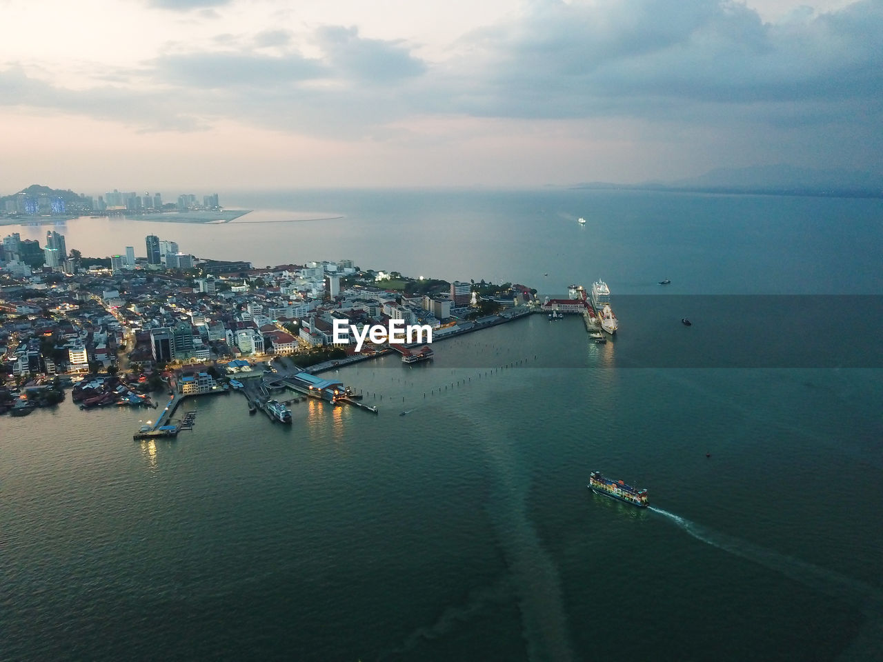 Ferry carry passenger and transport arrive penang georgetown in dusk hour.